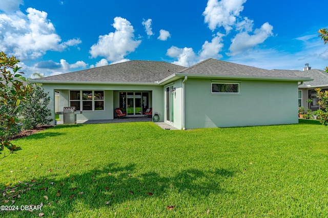 3651 Pini Ave, New Smyrna Beach, FL 32168 - back of house featuring a lawn