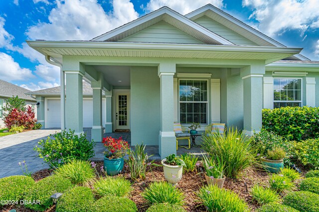 3651 Pini Ave, New Smyrna Beach, FL 32168 - view of front of property with a garage and a porch