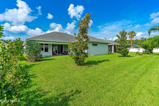 3651 Pini Ave, New Smyrna Beach, FL 32168 - back of property featuring a yard