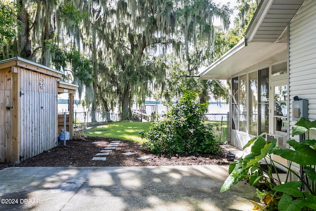 view of yard with a shed and a sunroom