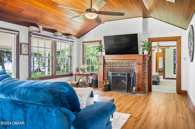 living room featuring light wood-type flooring, a fireplace, vaulted ceiling, and wooden ceiling