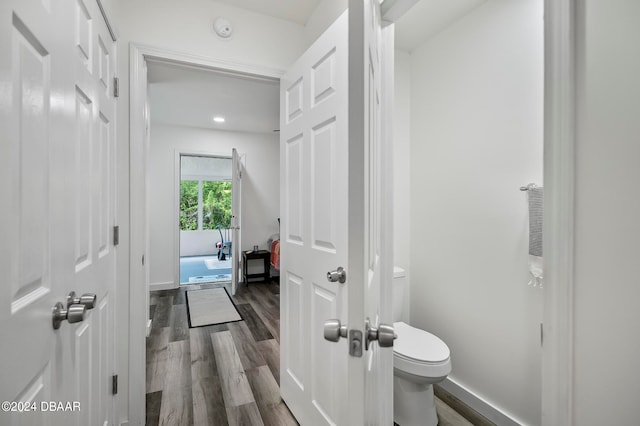 bathroom featuring wood-type flooring and toilet