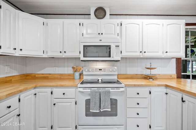 kitchen featuring backsplash, white appliances, white cabinetry, and butcher block countertops