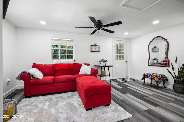 living room featuring dark hardwood / wood-style flooring and ceiling fan