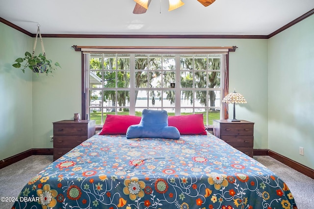 carpeted bedroom featuring multiple windows, ceiling fan, and crown molding