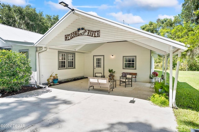 back of property with a patio area and a lawn