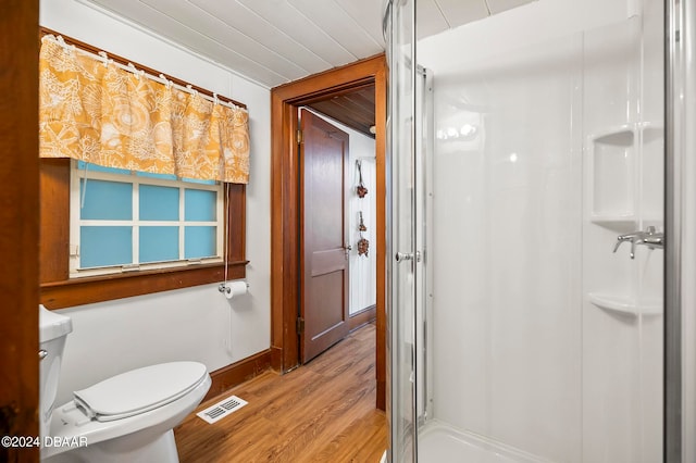 bathroom with walk in shower, hardwood / wood-style floors, and toilet