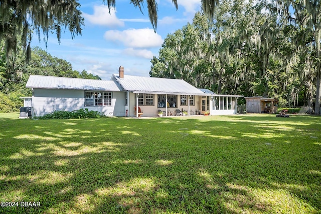 back of property featuring a yard