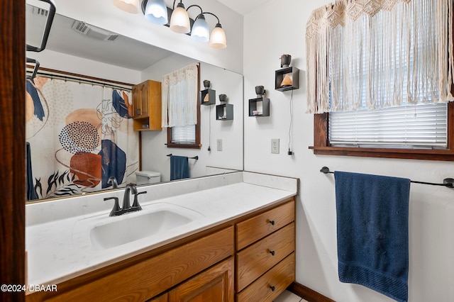 bathroom featuring vanity and toilet