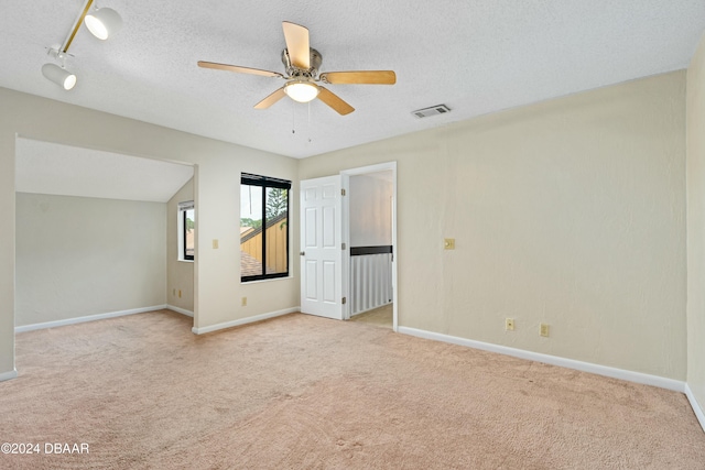 spare room with ceiling fan, light colored carpet, and track lighting