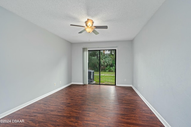 spare room with a textured ceiling, ceiling fan, and dark wood-type flooring