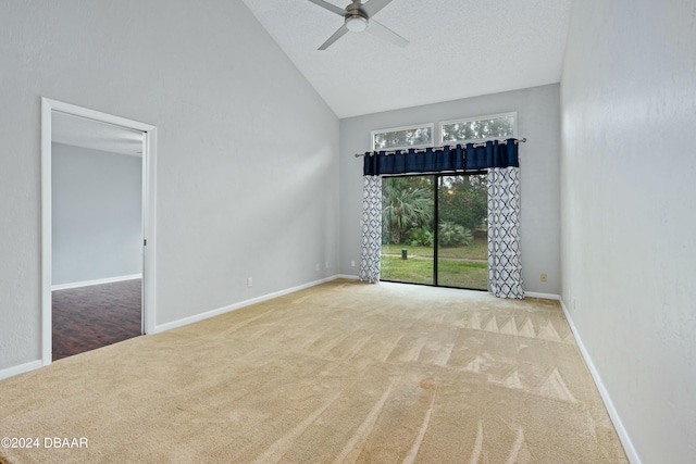 carpeted empty room featuring ceiling fan and vaulted ceiling