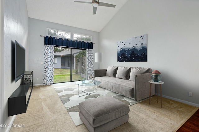 living room with ceiling fan, high vaulted ceiling, a healthy amount of sunlight, and wood-type flooring