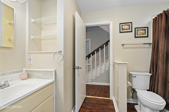 bathroom with hardwood / wood-style floors, vanity, and toilet