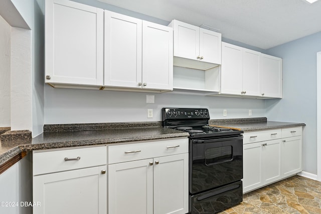 kitchen featuring electric range and white cabinets