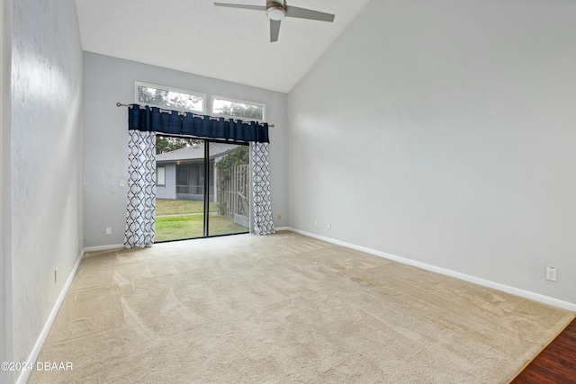 carpeted spare room featuring ceiling fan and lofted ceiling