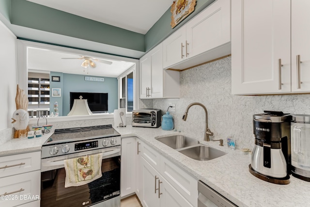 2800 N Atlantic Ave Unit 515, Daytona Beach, FL 32118 - kitchen featuring appliances with stainless steel finishes, a sink, white cabinetry, tasteful backsplash, and ceiling fan