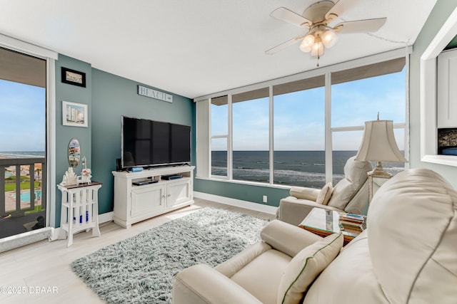 2800 N Atlantic Ave Unit 515, Daytona Beach, FL 32118 - living room with ceiling fan, baseboards, and light wood-style floors