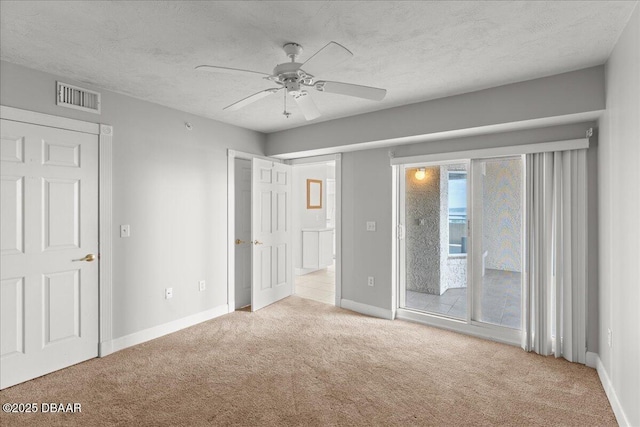 3425 S Atlantic Ave Unit 902, Daytona Beach Shores, FL 32118 - unfurnished bedroom featuring carpet, access to outside, baseboards, and a textured ceiling