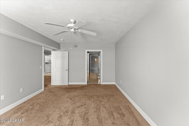 3425 S Atlantic Ave Unit 902, Daytona Beach Shores, FL 32118 - unfurnished bedroom featuring carpet flooring, baseboards, a textured ceiling, and a ceiling fan