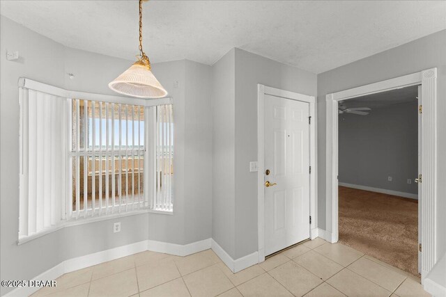3425 S Atlantic Ave Unit 902, Daytona Beach Shores, FL 32118 - empty room featuring baseboards, light tile patterned flooring, and ceiling fan