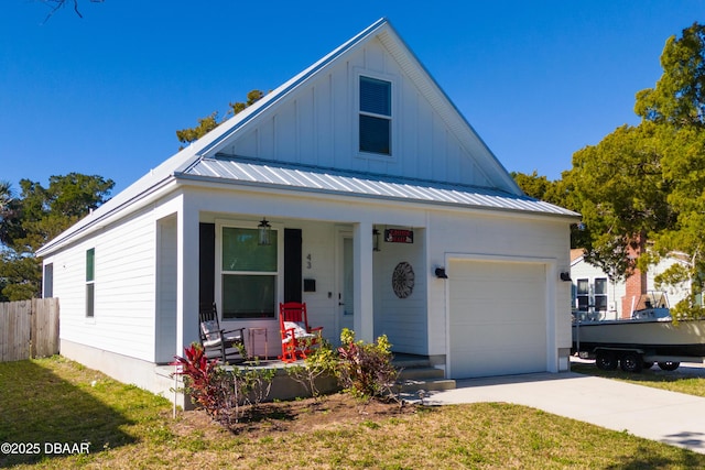 view of front of house featuring a front lawn, covered porch, and a garage