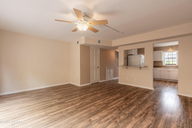 108 Mitchell Pl, Daytona Beach, FL 32118 - unfurnished living room with a ceiling fan, wood finished floors, baseboards, and a sink