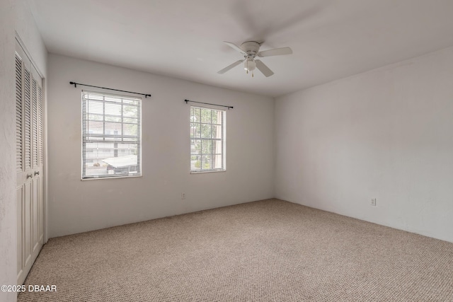 108 Mitchell Pl, Daytona Beach, FL 32118 - unfurnished bedroom with light colored carpet, a closet, and ceiling fan