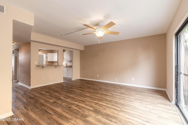 108 Mitchell Pl, Daytona Beach, FL 32118 - unfurnished living room featuring ceiling fan, wood finished floors, and baseboards