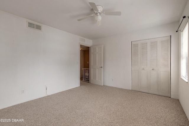 108 Mitchell Pl, Daytona Beach, FL 32118 - unfurnished bedroom featuring carpet, a closet, and ceiling fan
