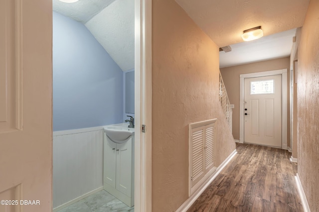108 Mitchell Pl, Daytona Beach, FL 32118 - entryway with a sink, a textured ceiling, wood finished floors, wainscoting, and a textured wall
