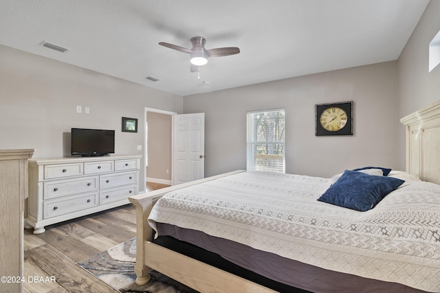 bedroom with ceiling fan and light hardwood / wood-style floors