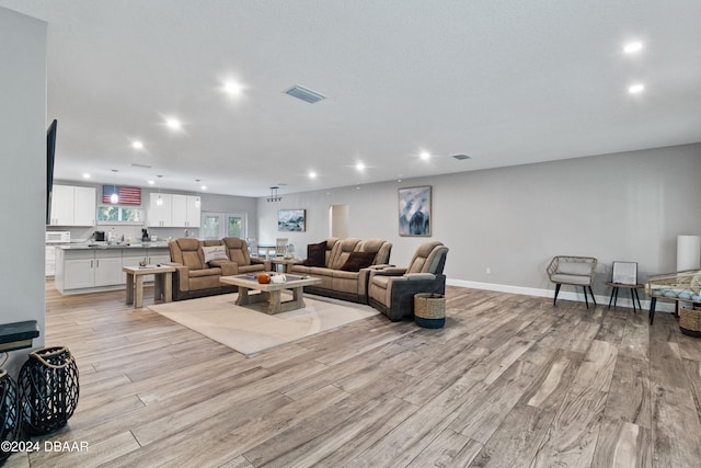 living room with light hardwood / wood-style flooring