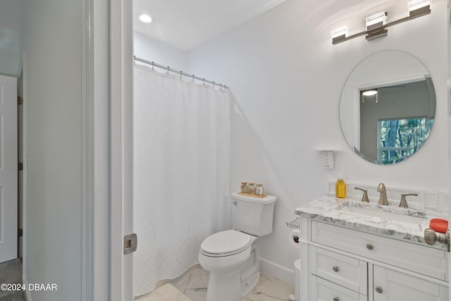 bathroom featuring curtained shower, vanity, and toilet