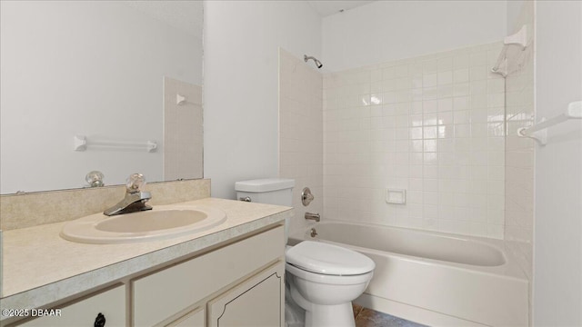 full bathroom with tiled shower / bath, vanity, and toilet