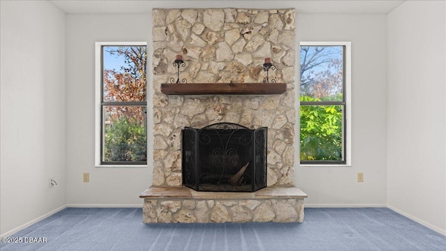 carpeted living room with a healthy amount of sunlight and a fireplace