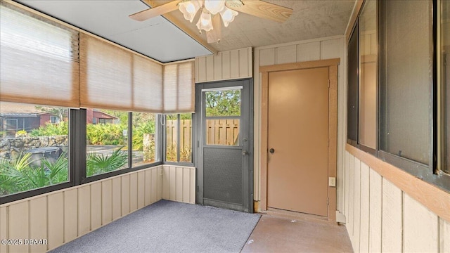 unfurnished sunroom with ceiling fan