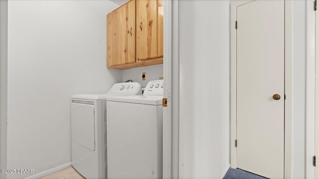 laundry room with cabinets and washer and clothes dryer