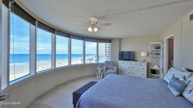 bedroom with ceiling fan and a textured ceiling