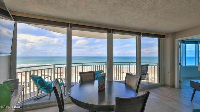 sunroom / solarium with a water view