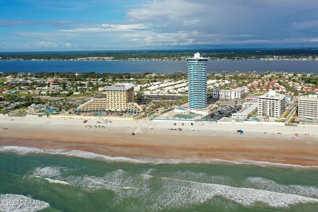 drone / aerial view with a water view and a view of the beach