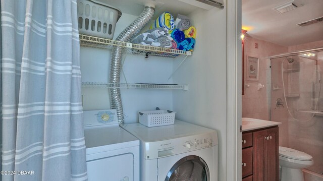 laundry room with washing machine and clothes dryer