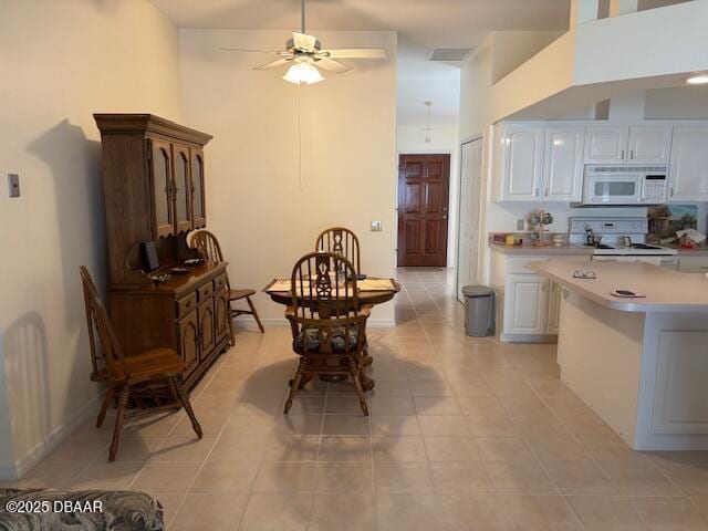 tiled dining area with ceiling fan