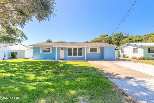 ranch-style home with a front lawn and central AC unit