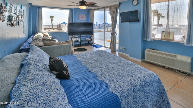 1233 S Atlantic Ave Unit 102, Daytona Beach, FL 32118 - bedroom featuring tile patterned floors, access to outside, a wall unit AC, and a ceiling fan