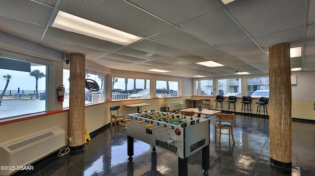1233 S Atlantic Ave Unit 102, Daytona Beach, FL 32118 - recreation room featuring a drop ceiling and a wall unit AC