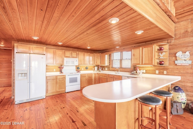 109 Avalon Dr, Ormond Beach, FL 32176 - kitchen with light wood-style floors, light countertops, white appliances, and light brown cabinets