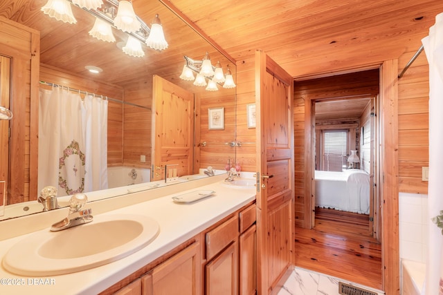 109 Avalon Dr, Ormond Beach, FL 32176 - ensuite bathroom with double vanity, wooden ceiling, a sink, and wooden walls