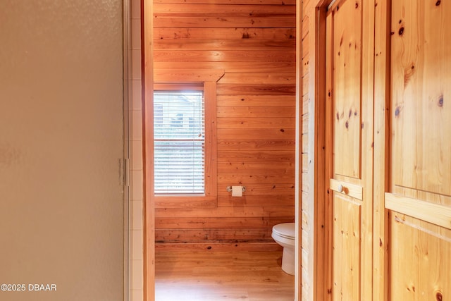 109 Avalon Dr, Ormond Beach, FL 32176 - bathroom with wood walls, wood finished floors, and toilet