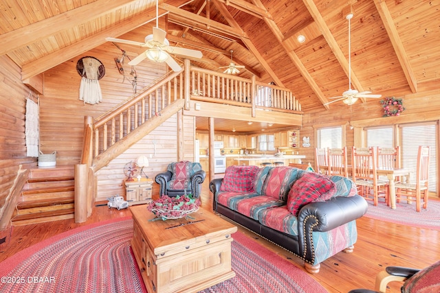 109 Avalon Dr, Ormond Beach, FL 32176 - living room featuring wood walls, wood finished floors, wood ceiling, stairway, and beam ceiling